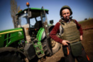 Picture of Ukrainian farmers don bulletproof vests to plough frontline fields