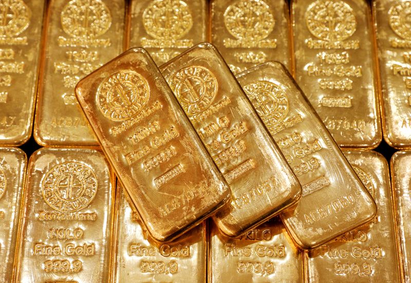 Gold prices dented by stronger dollar ahead of Fed minutes