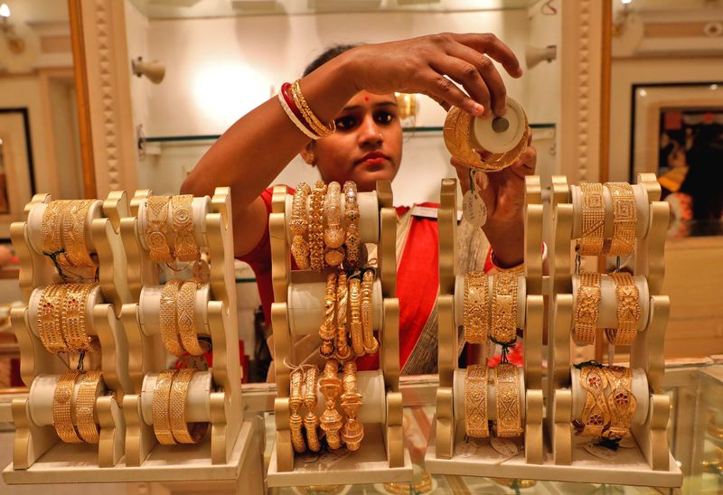 Gold sulks near 7-month low as dollar basks in safe-haven demand