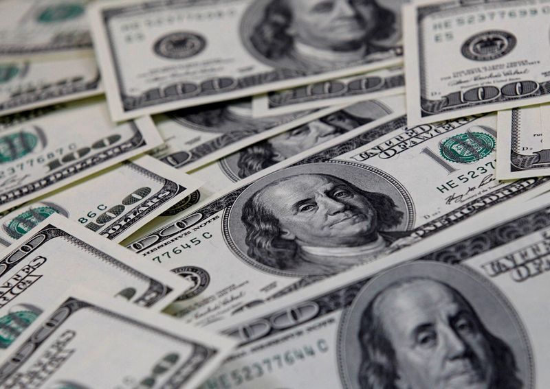 Dollar jumps to two-week high, euro slides as German inflation eases